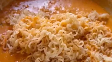 Creamy butter garlic cheesy noodles topped with cheese and spring onions